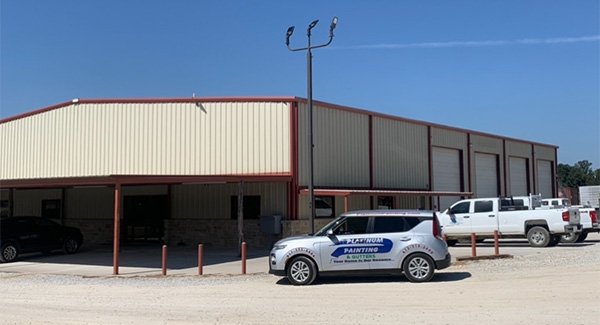 A white building with cars parked nearby