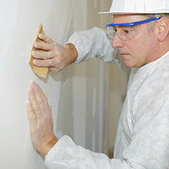 Man removing textured paint