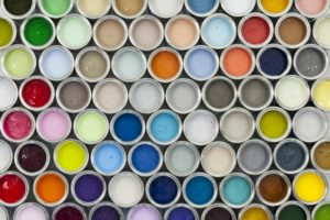 all different colors of paint samples sitting next to each other in canisters