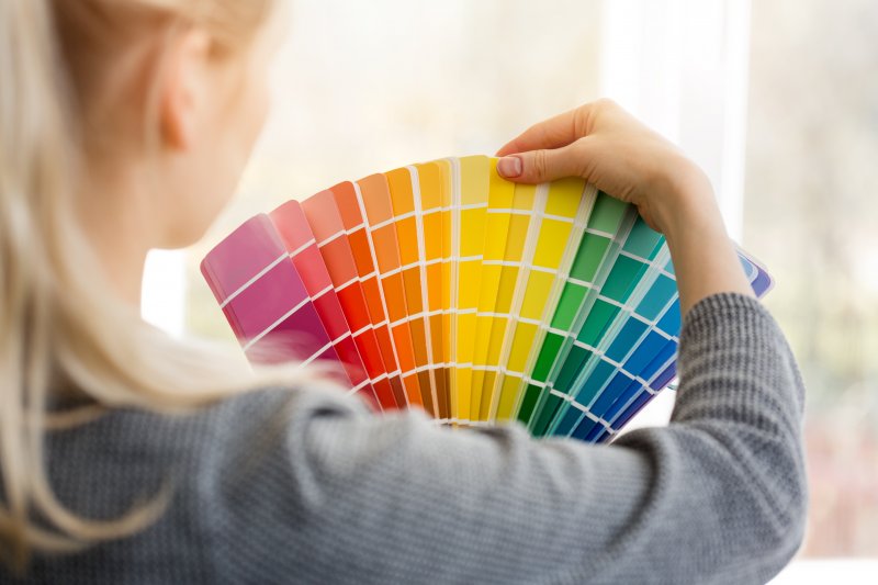 young woman choosing paint color for home