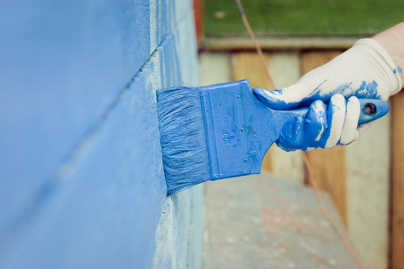 closeup of a man exterior painting