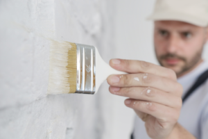 a closeup of a painter holding a brush