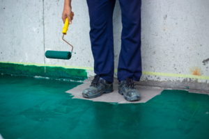 a painter who has painted the floor around him