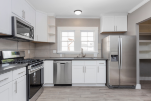 a painted kitchen with several stainless steel appliances