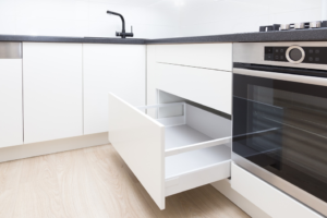 a closeup of a kitchen with handleless cabinets 