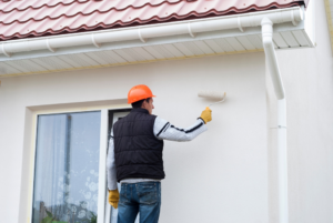 a homeowner painting their house